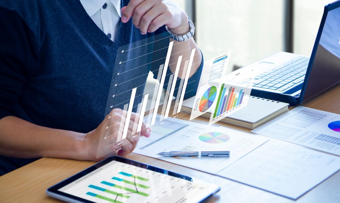 Businessman with virtual reality graphics is deeply reviewing financial reports for a return on investment, ROI, or investment risk analysis.